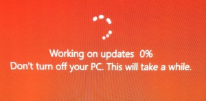 An orange computer screen indicating that updates are in progress.