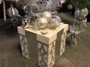 A tastefully decorated gift box under the Christmas tree